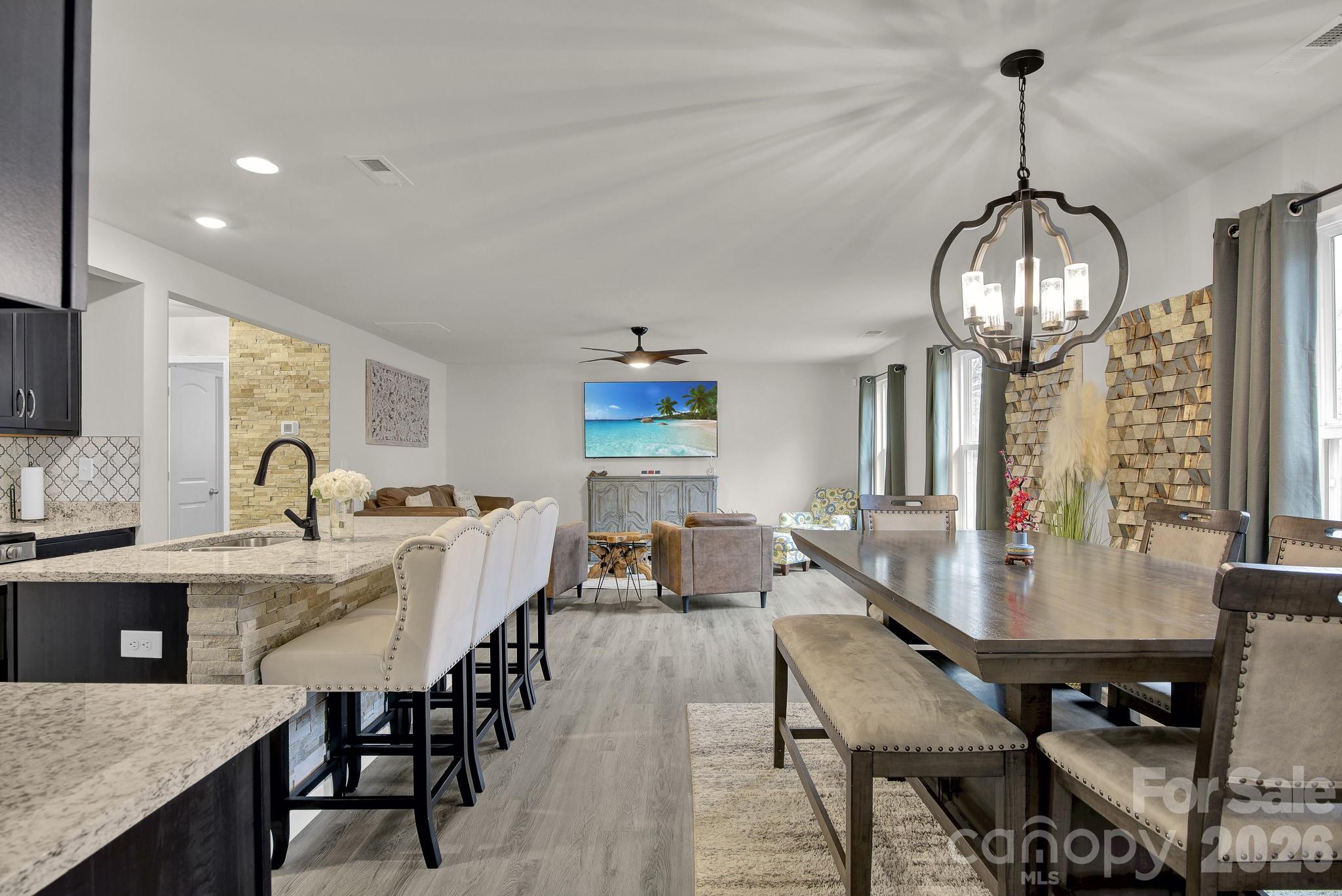 865 Old Linwood Road Lexington, NC 27292 - Photo 23 of 44 a view of a dining room with furniture a chandelier and wooden floor