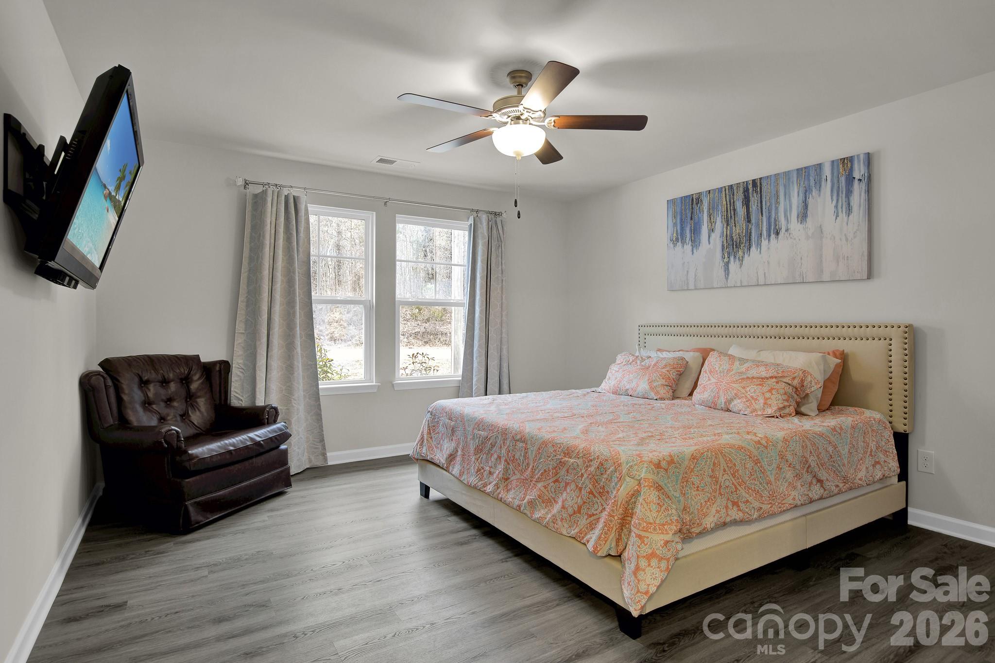865 Old Linwood Road Lexington, NC 27292 - Photo 24 of 44 a bedroom with a bed a couch and a flat tv screen on the dresser