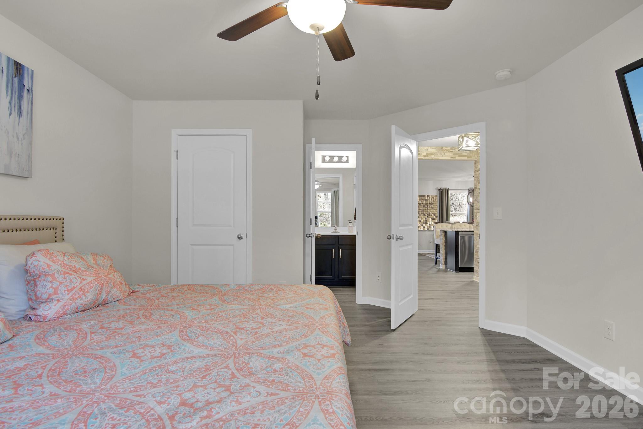 865 Old Linwood Road Lexington, NC 27292 - Photo 25 of 44 a bedroom with a bed and a chandelier