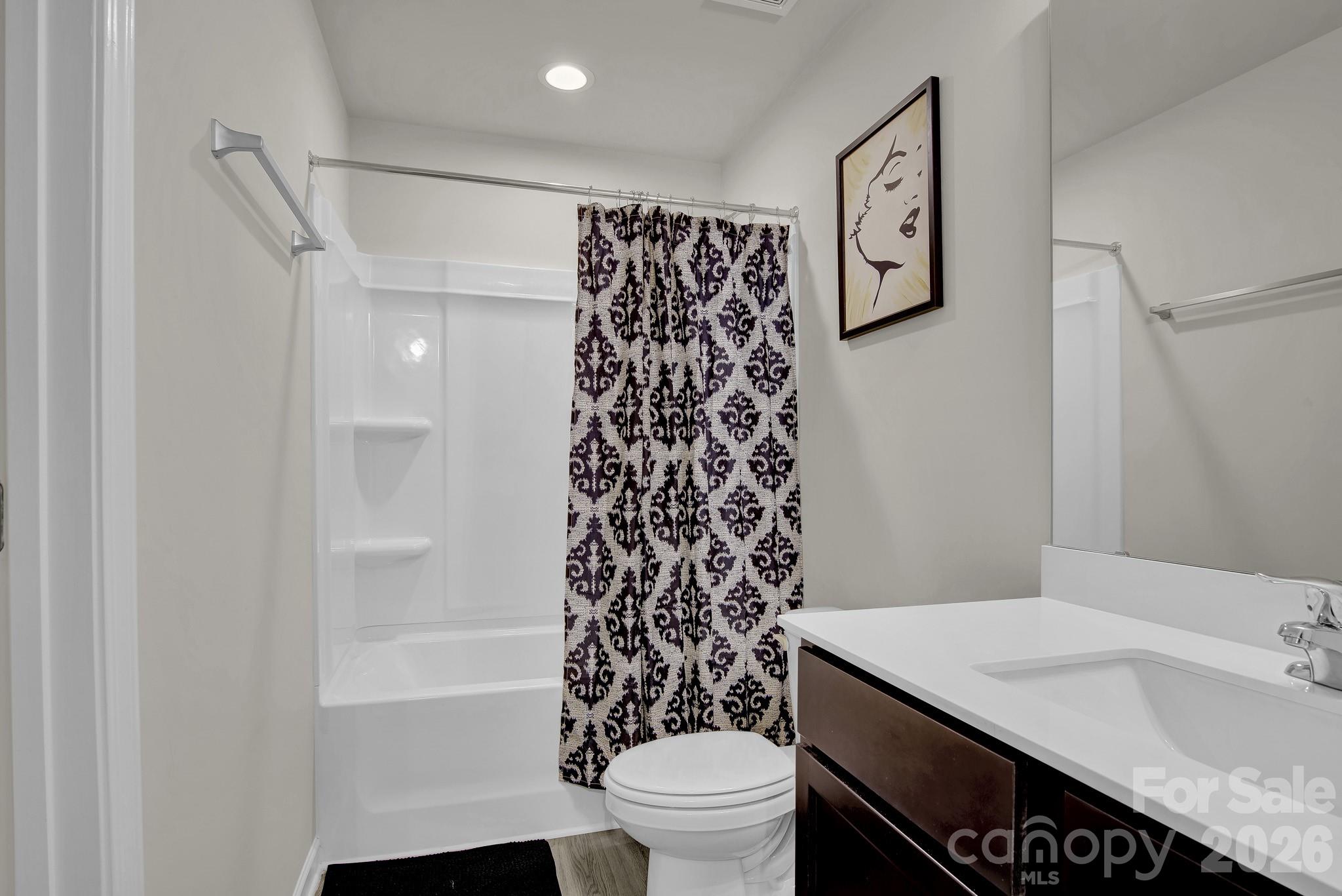 865 Old Linwood Road Lexington, NC 27292 - Photo 26 of 44 a bathroom with a sink a toilet and shower curtain