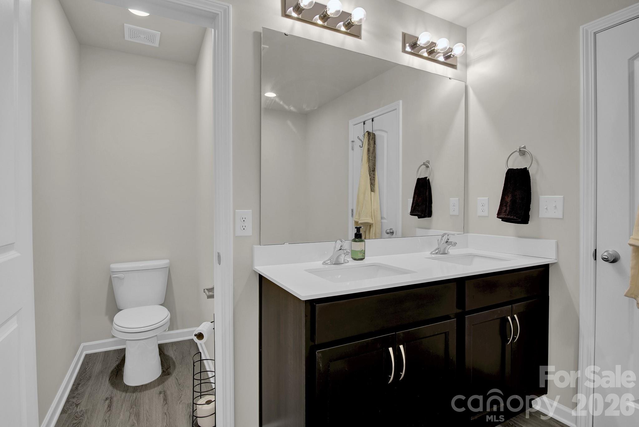 865 Old Linwood Road Lexington, NC 27292 - Photo 32 of 44 a bathroom with a toilet sink and mirror