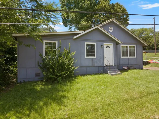 a front view of house with yard and green space