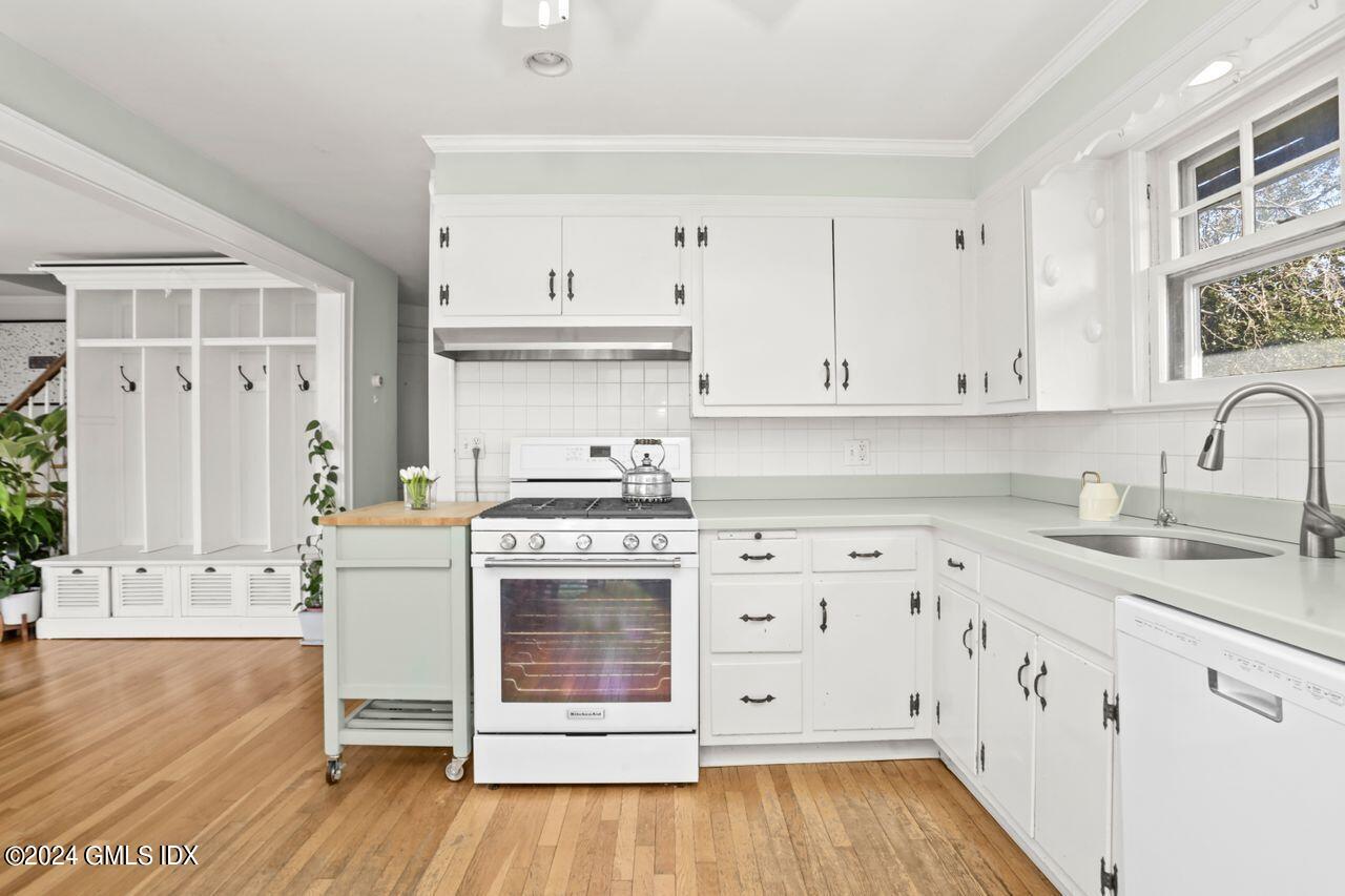 17 Center Road Old Greenwich, CT 06870 - Photo 4 of 30 a kitchen with granite countertop white cabinets and white appliances