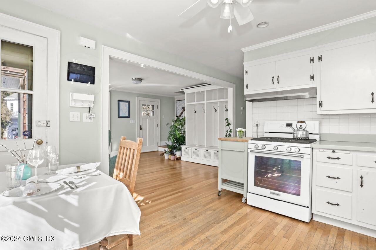 17 Center Road Old Greenwich, CT 06870 - Photo 6 of 30 a kitchen with white cabinets and white appliances