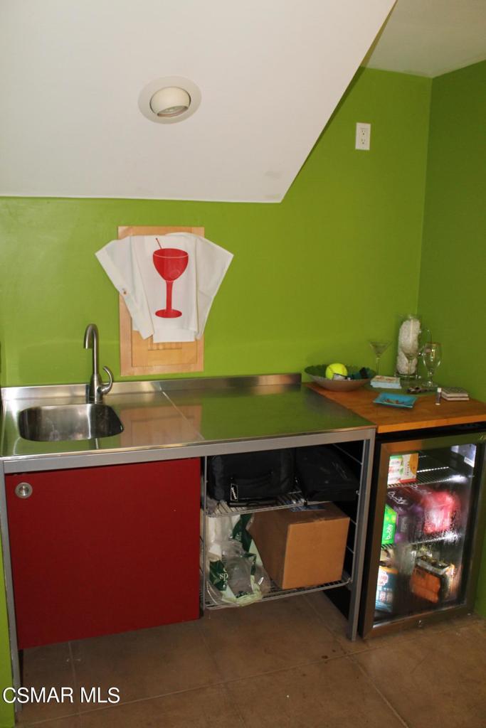 369 Cahuenga Drive Oxnard, CA 93035 - Photo 28 of 36 a room with a fireplace and a flat screen tv