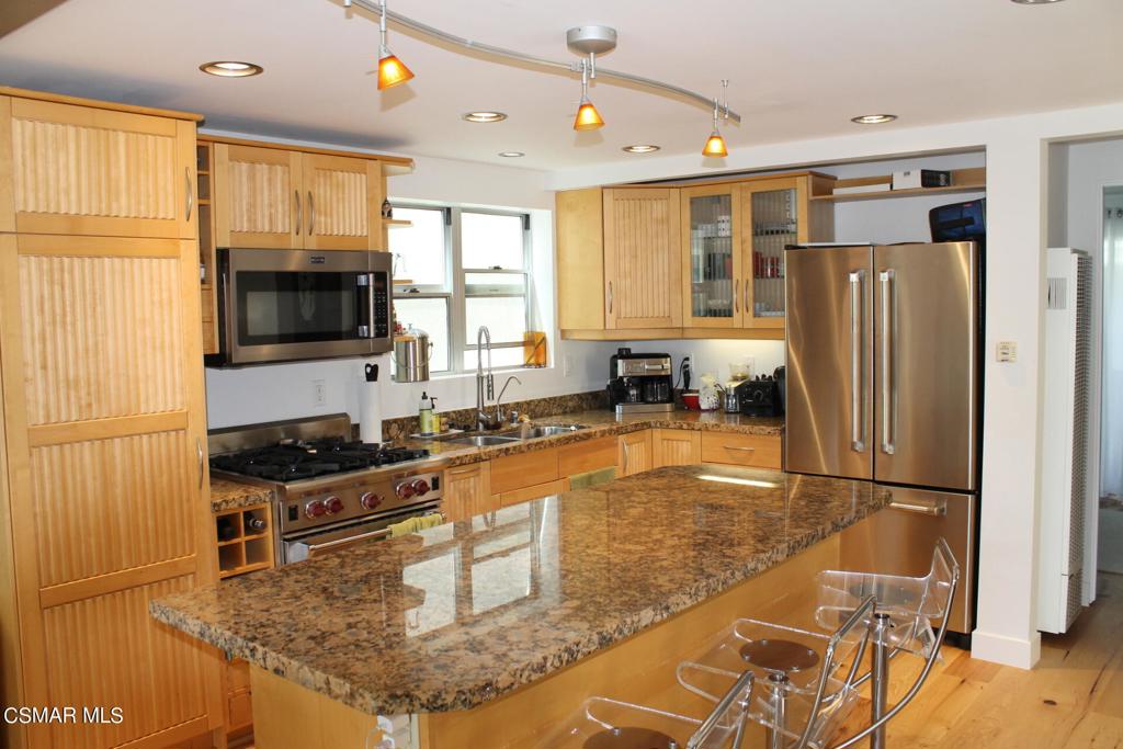369 Cahuenga Drive Oxnard, CA 93035 - Photo 8 of 36 a kitchen with granite countertop a refrigerator stove top oven and sink