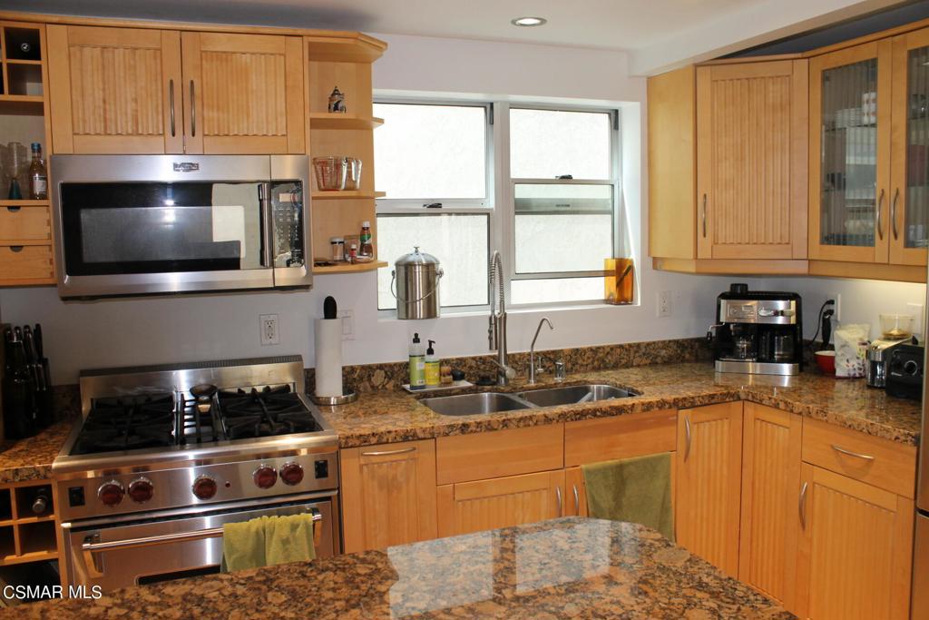 369 Cahuenga Drive Oxnard, CA 93035 - Photo 10 of 36 a kitchen with stainless steel appliances granite countertop a stove a sink and a microwave