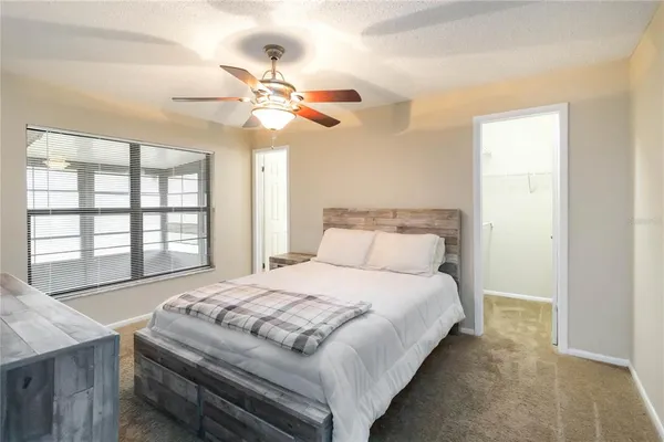 a bedroom with a large bed and a chandelier