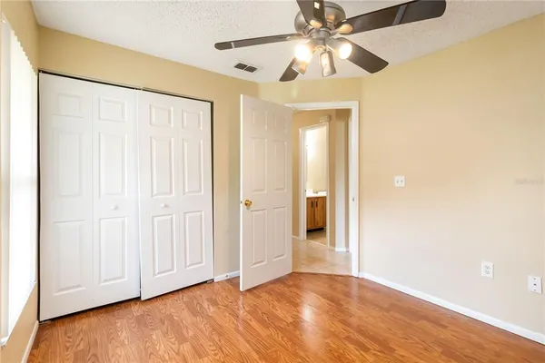 a view of an empty room with wooden floor
