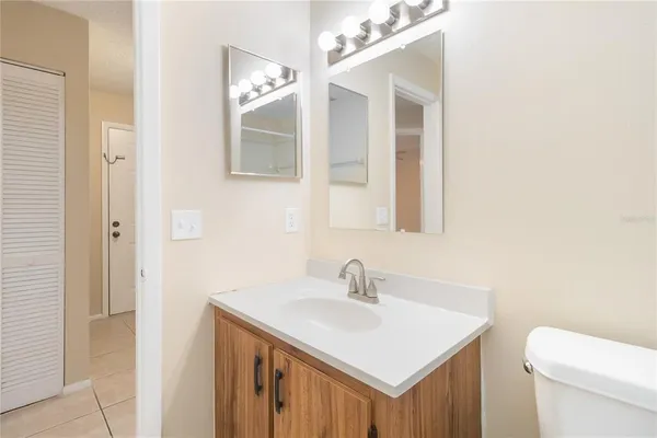 a bathroom with a sink toilet and mirror