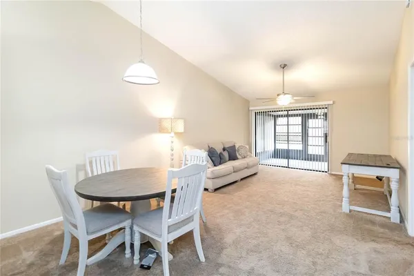 a living room with furniture a chandelier and a table