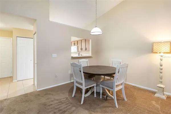 a view of a dining room with furniture and a chandelier