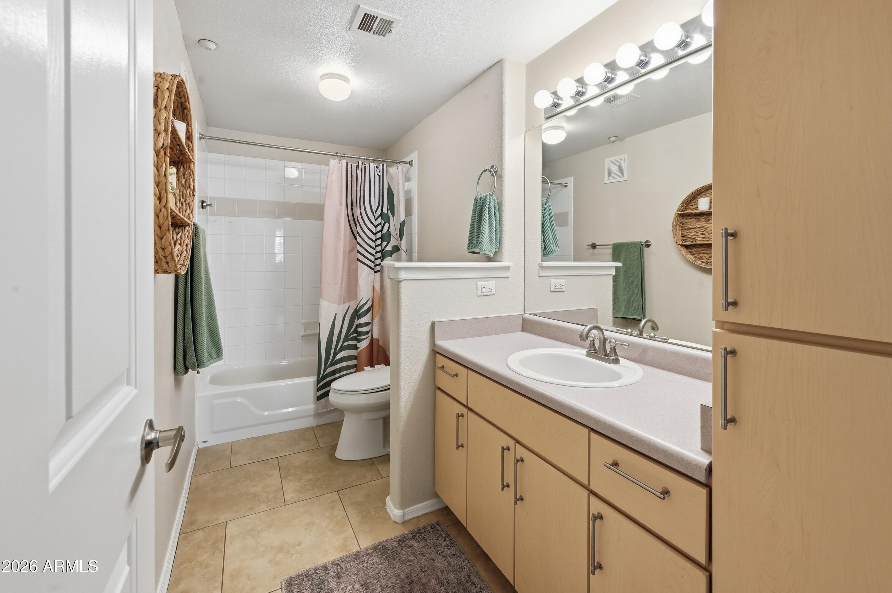 5303 North 7th Street, Unit 220 Phoenix, AZ 85014 - Photo 23 of 33 a bathroom with a sink a toilet and a mirror