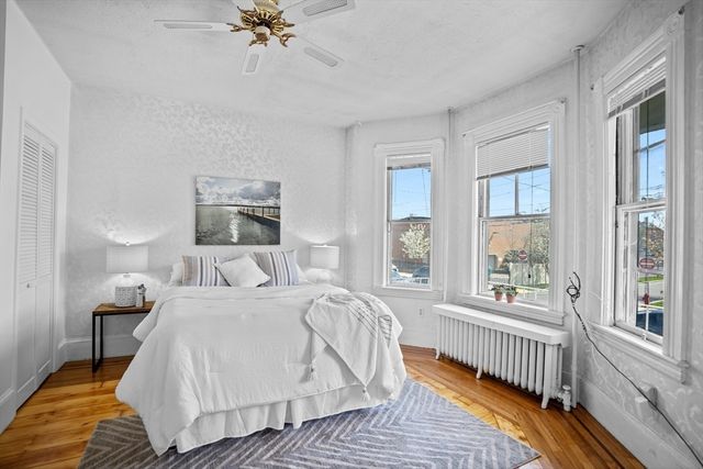 a spacious bedroom with a bed and a large window