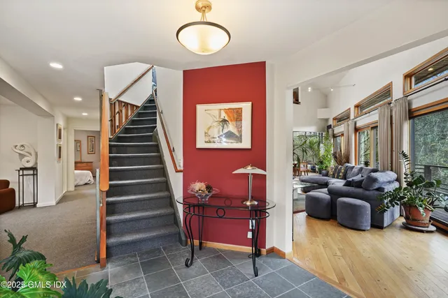 a dinning table and a potted plant in a living room
