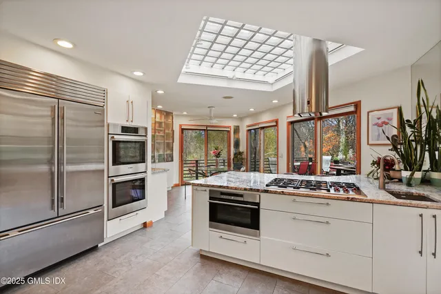 a spacious bedroom with a bed and large windows