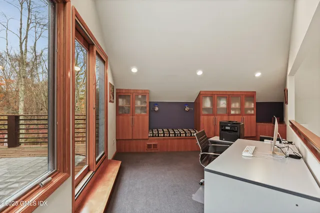 a bedroom with a bed a mirror and wall painting