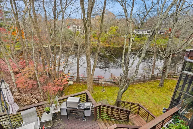 a view of balcony with wooden floor and fence