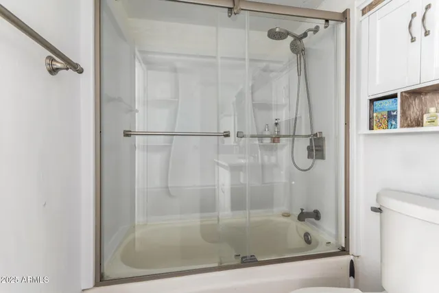 a bathroom with a shower and a bath tub