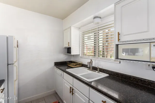 a kitchen with a sink and a stove top oven