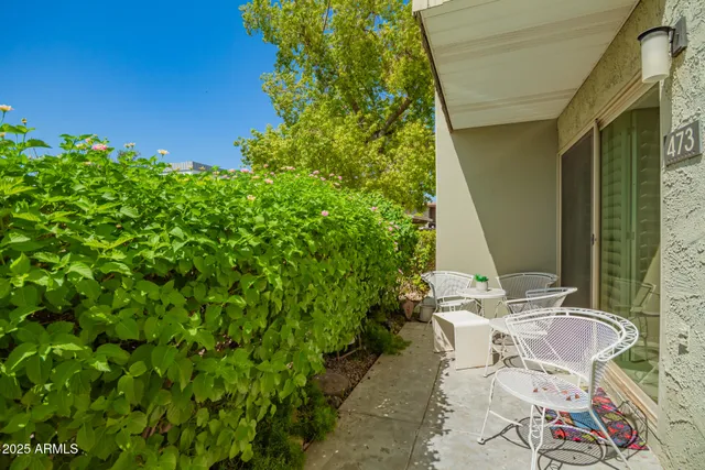 a backyard of a house with table and chairs