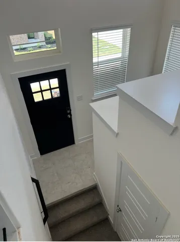 a view of staircase with wooden floor and a window