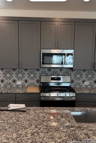 a kitchen with a stove and a microwave