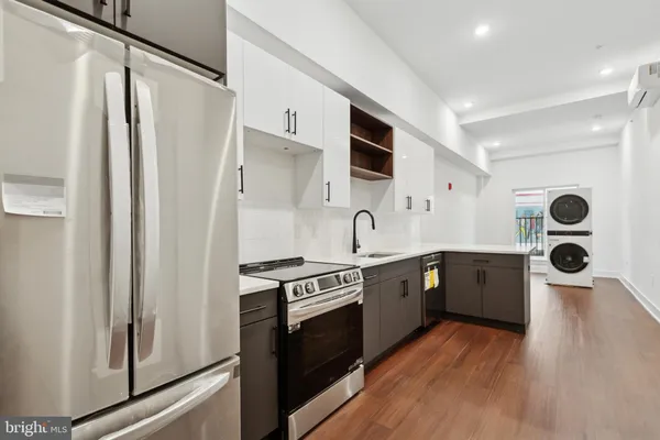 a kitchen with stainless steel appliances a stove a sink and a refrigerator