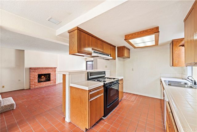 a kitchen with stainless steel appliances sink stove and cabinets