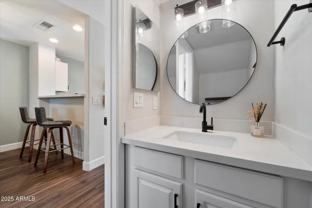 a bathroom with a sink and a mirror