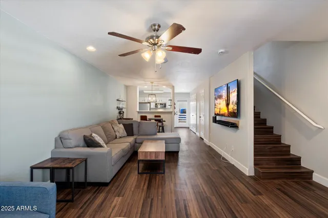 a living room with furniture and a wooden floor