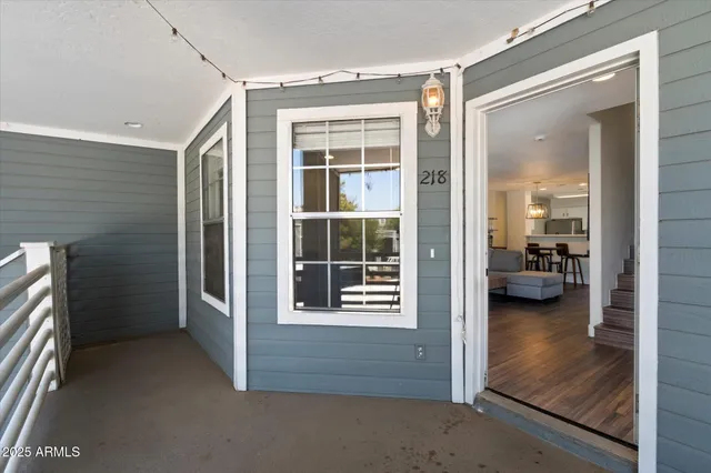 a view of a hallway and a livingroom with furniture
