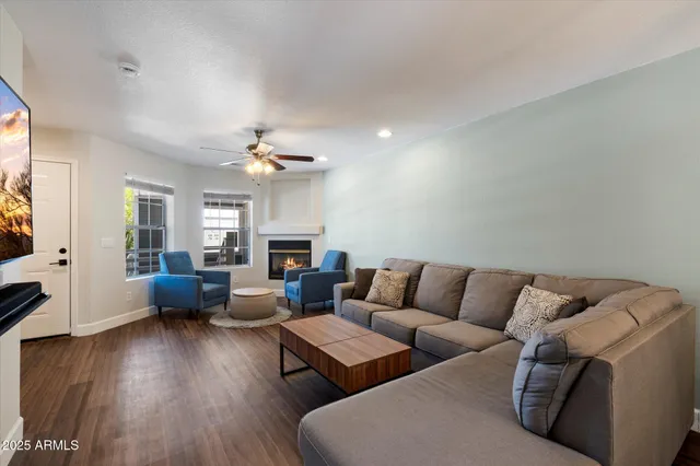 a living room with furniture and wooden floor