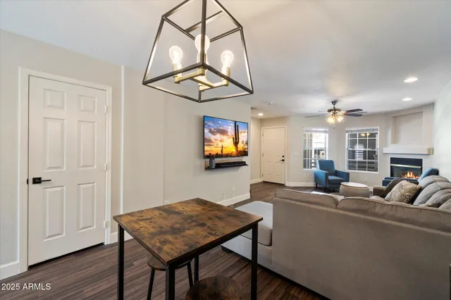a living room with a table and a chandelier