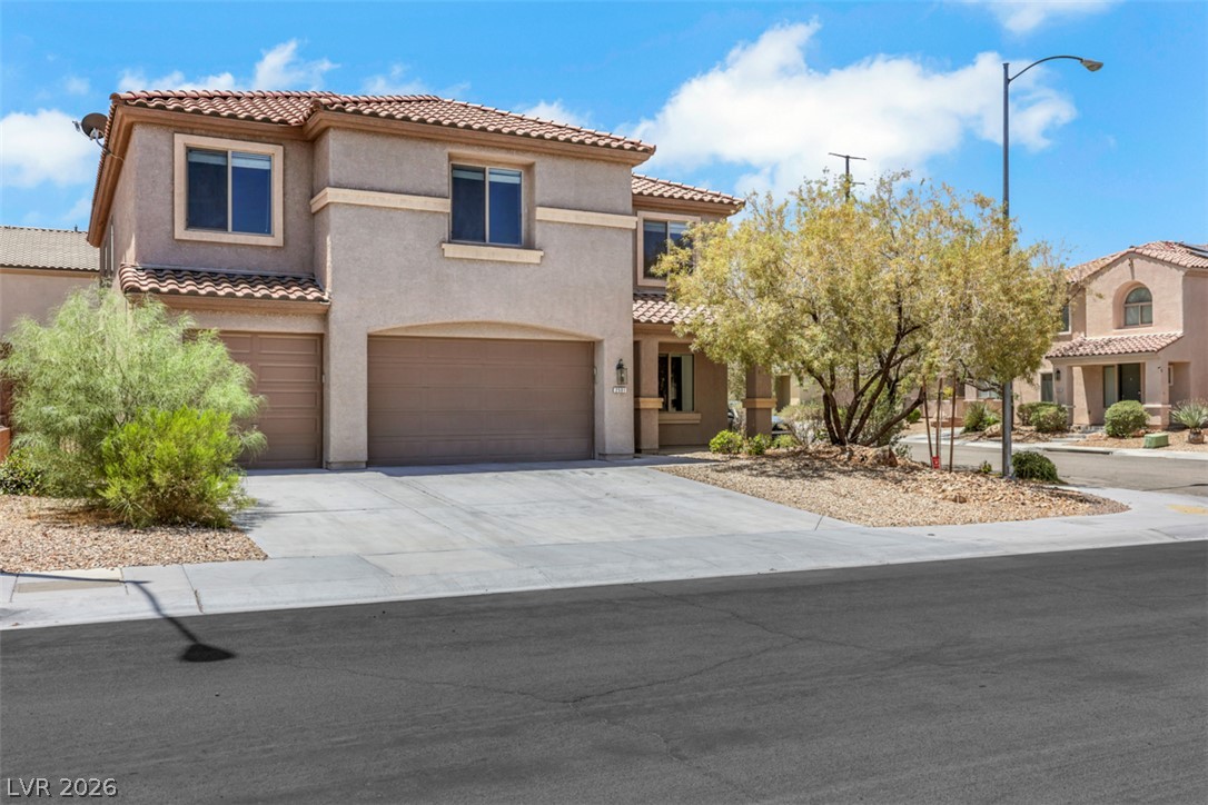 2501 Bechamel Place Henderson, NV 89044 - Photo 3 of 50 A well-maintained facade with an attached garage offers appealing curb appeal.