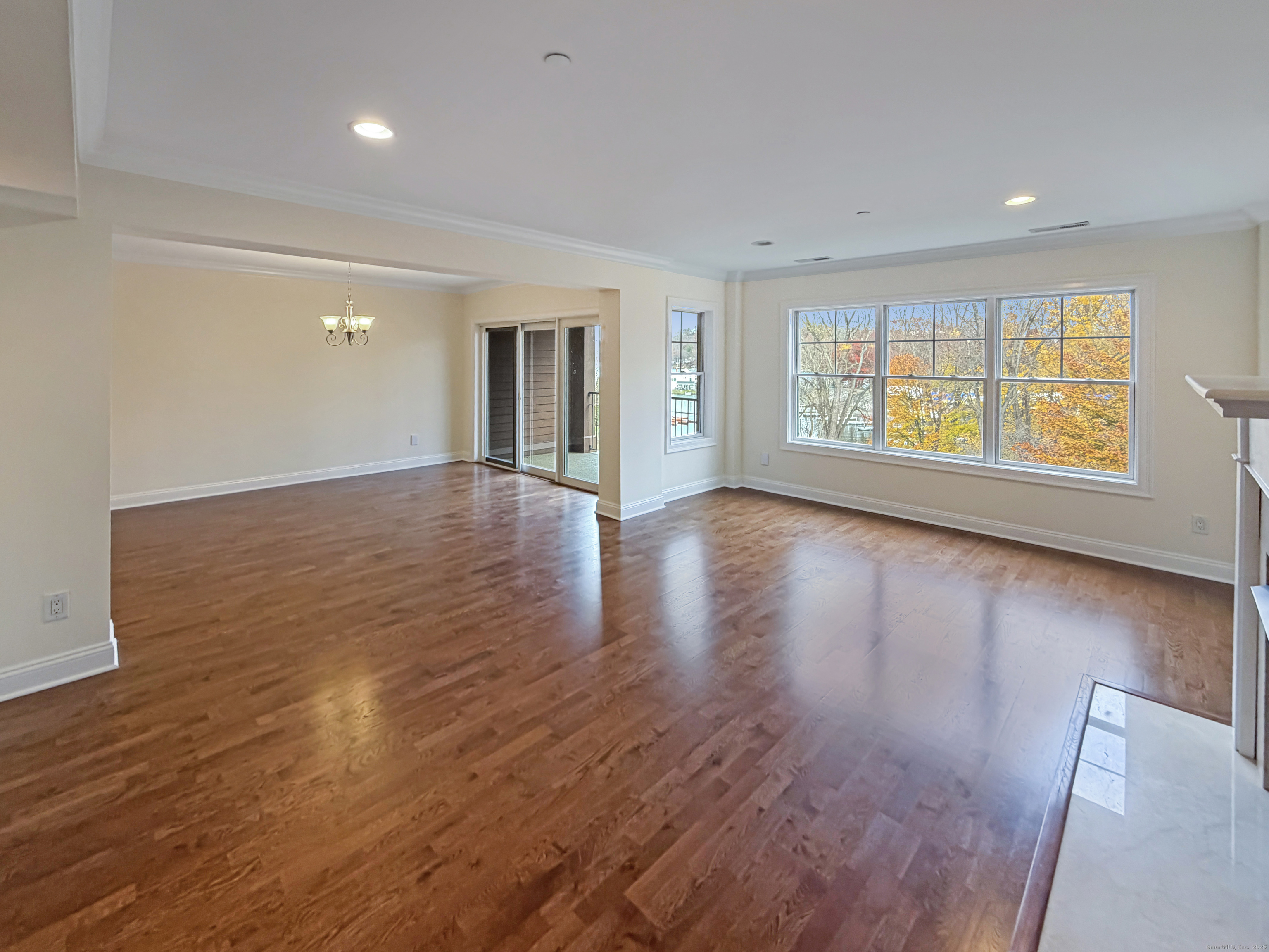 16 Hayestown Road, Unit A303 Danbury, CT 06811 - Photo 11 of 17 an empty room with wooden floor and windows