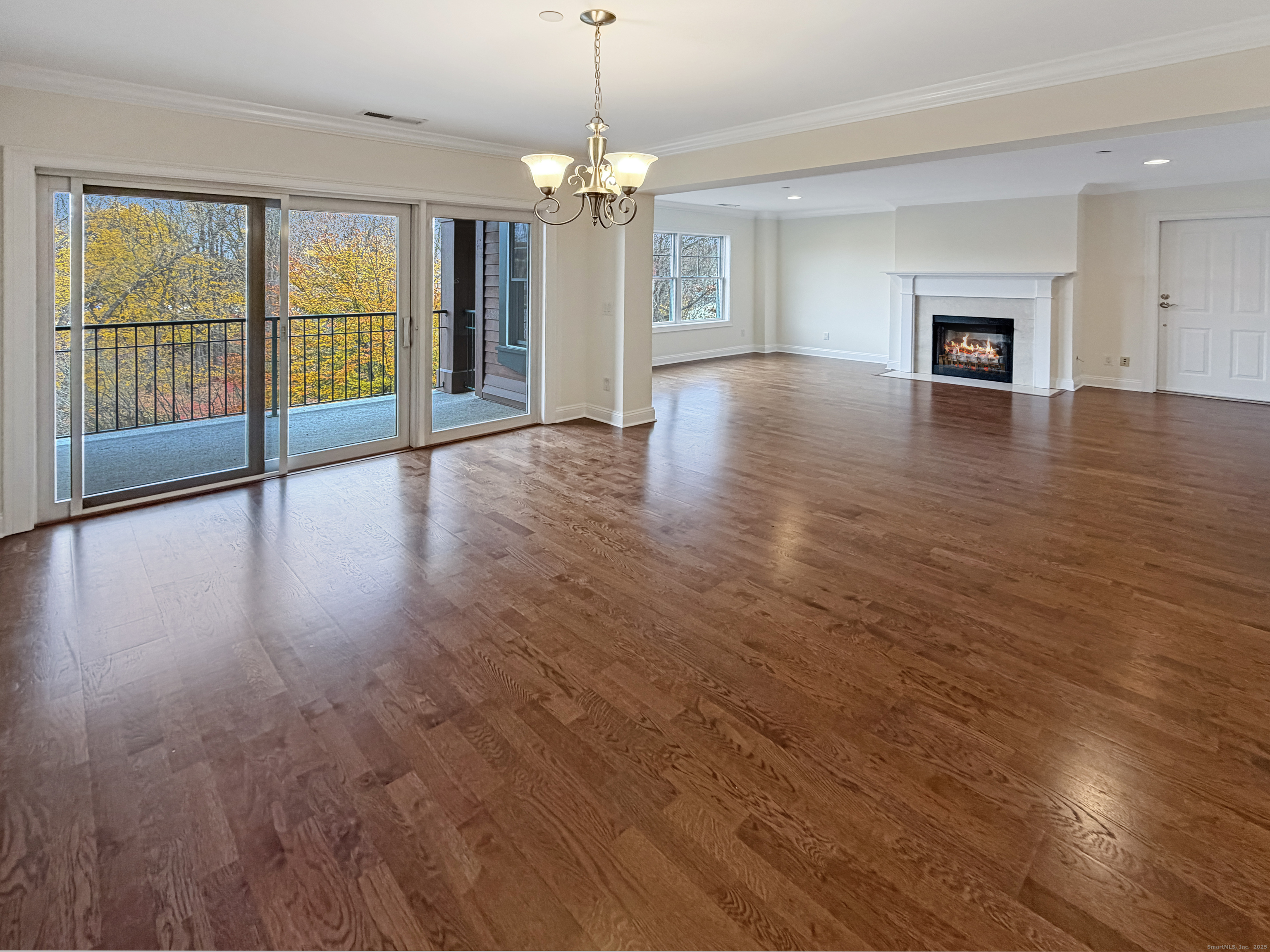 16 Hayestown Road, Unit A303 Danbury, CT 06811 - Photo 3 of 17 an empty room with wooden floor chandelier and windows