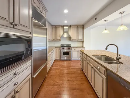 a kitchen with stainless steel appliances granite countertop a sink and stove