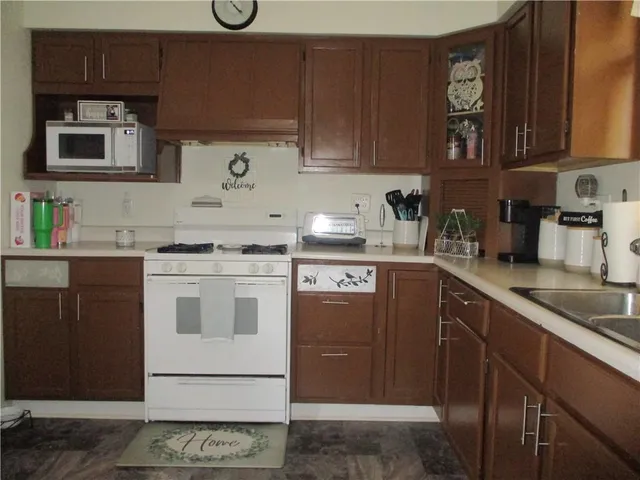 a kitchen with stainless steel appliances granite countertop a sink stove and cabinets