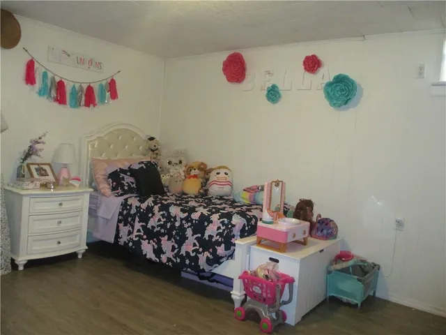 a bedroom with a bed and a dresser
