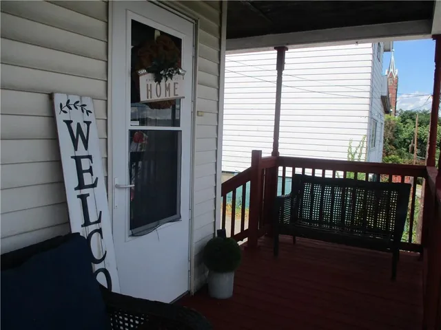 a view of a balcony with furniture and floor to ceiling window