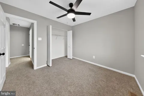 a view of a room with a ceiling fan