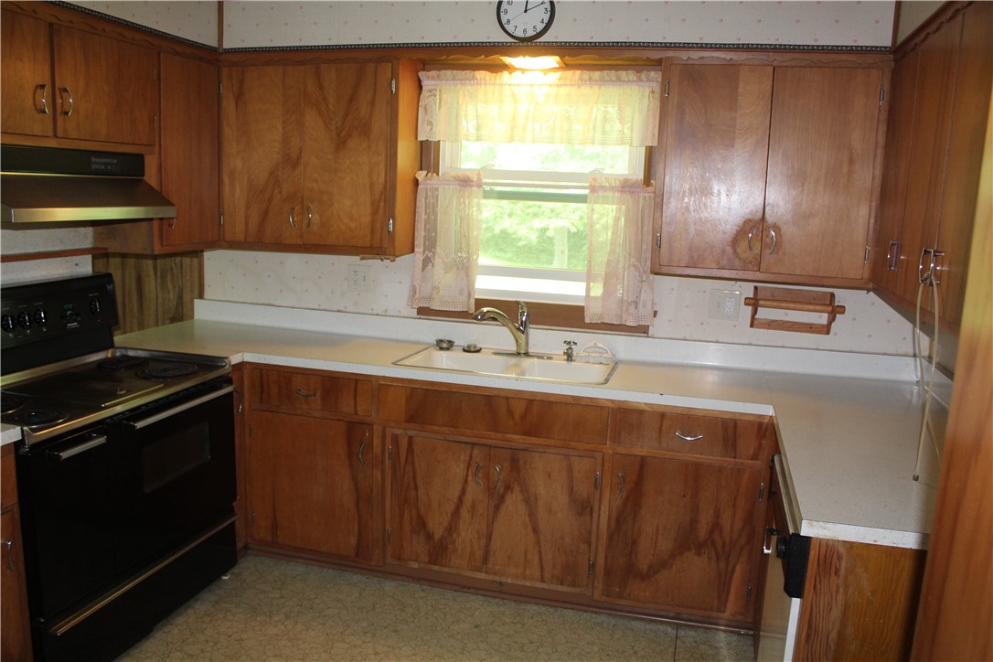 12735 Catlin Tilton Road Catlin, IL 61817 - Photo 5 of 22 a kitchen with a sink stove and cabinets