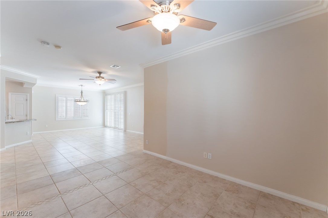 10481 Riverside Park Avenue Las Vegas, NV 89135 - Photo 17 of 51 Spare room with ornamental molding, a ceiling fan, and light tile patterned floors