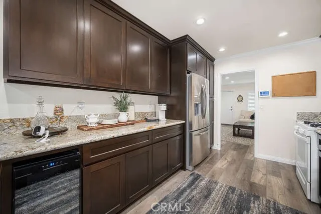 a kitchen with a sink dishwasher a refrigerator and cabinets