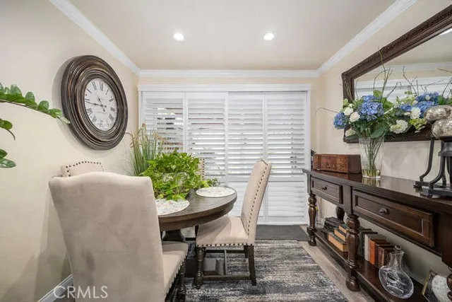 a dining room with furniture and a potted plant