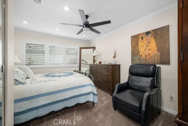 a bedroom with a bed couch and window