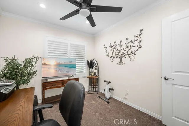 a view of a workspace with furniture and a window