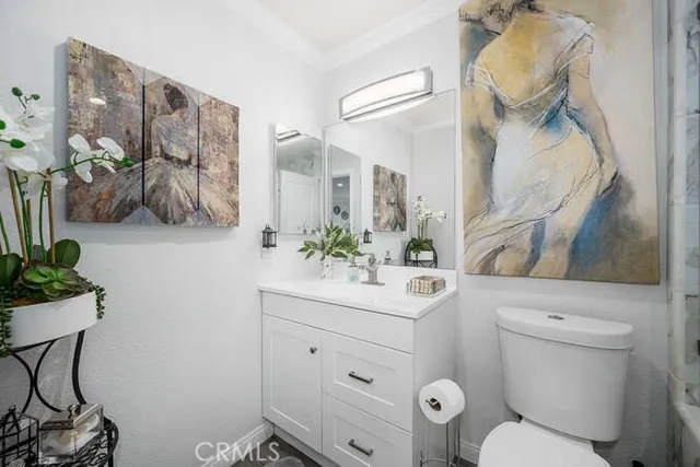 a bathroom with a sink vanity mirror and toilet