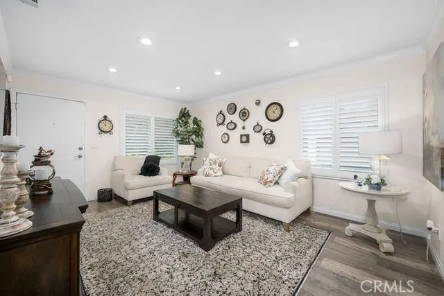 a living room with patio furniture and a rug
